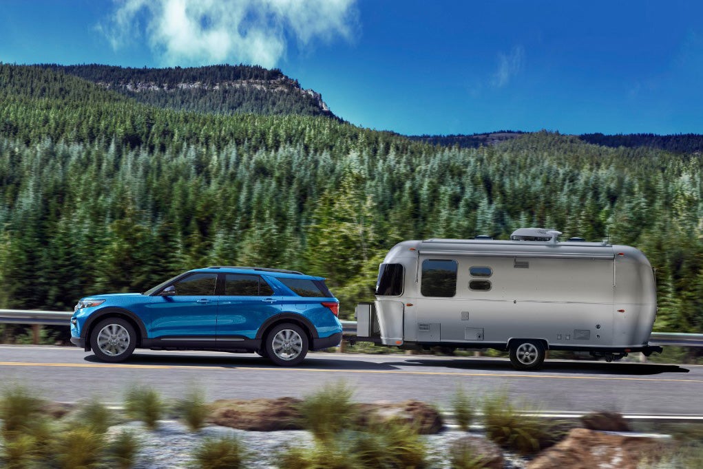 Ford Explorer Towing a Trailer on Scenic Road