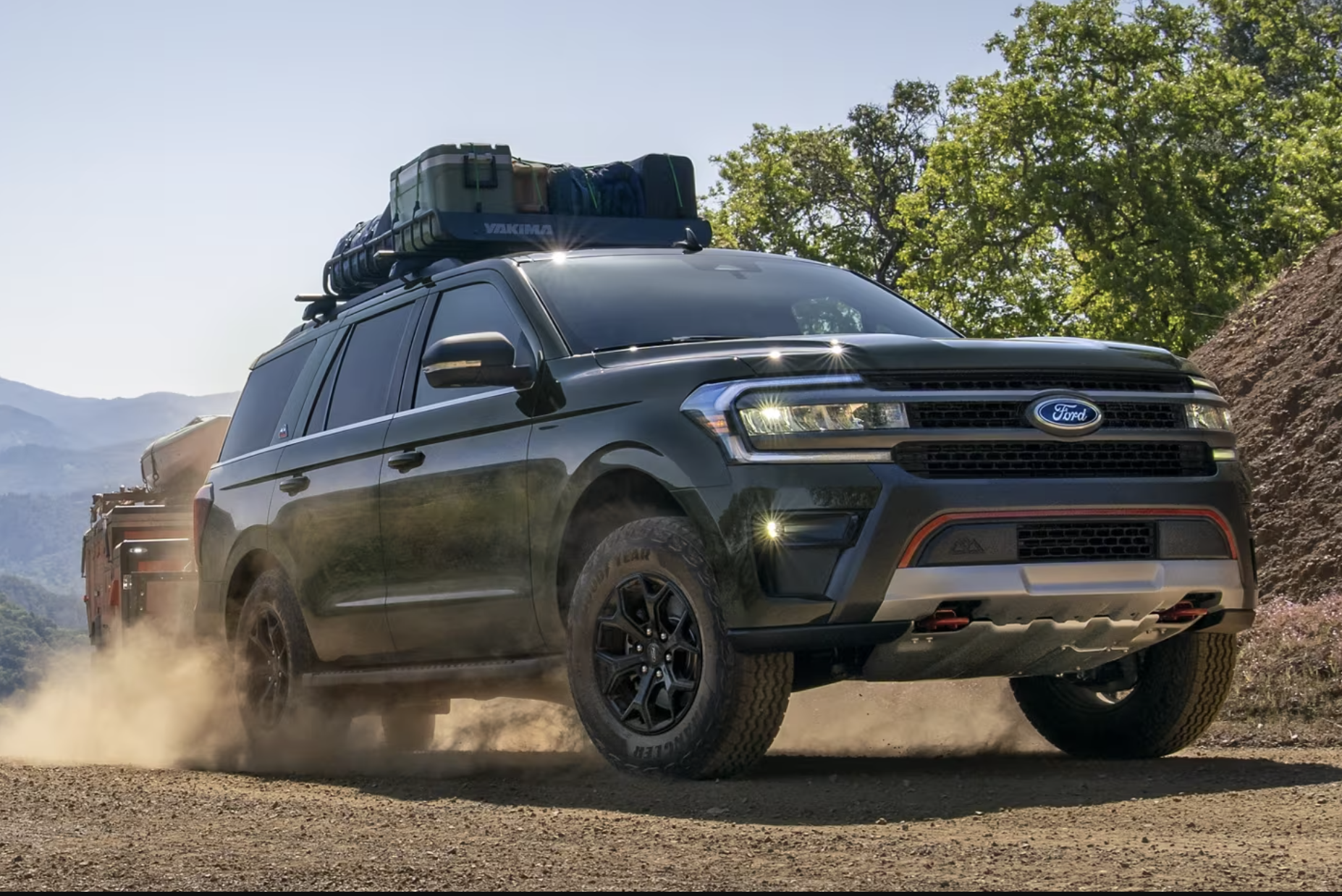 SUV with roof rack and trailer.