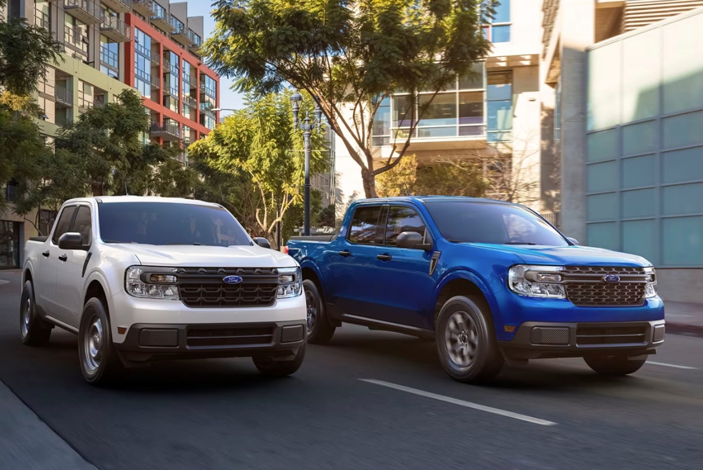 White and Blue Ford Mavericks Driving in the City