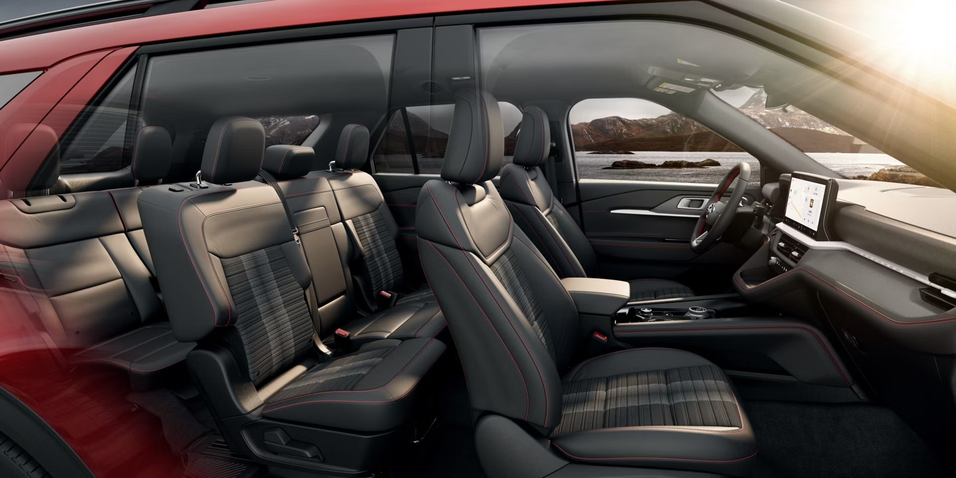 The full three rows of seating in the 2026 Ford Explorer in Phoenix are seen through the passenger side of the vehicle.